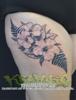 Black and grey floral tattoo on thigh